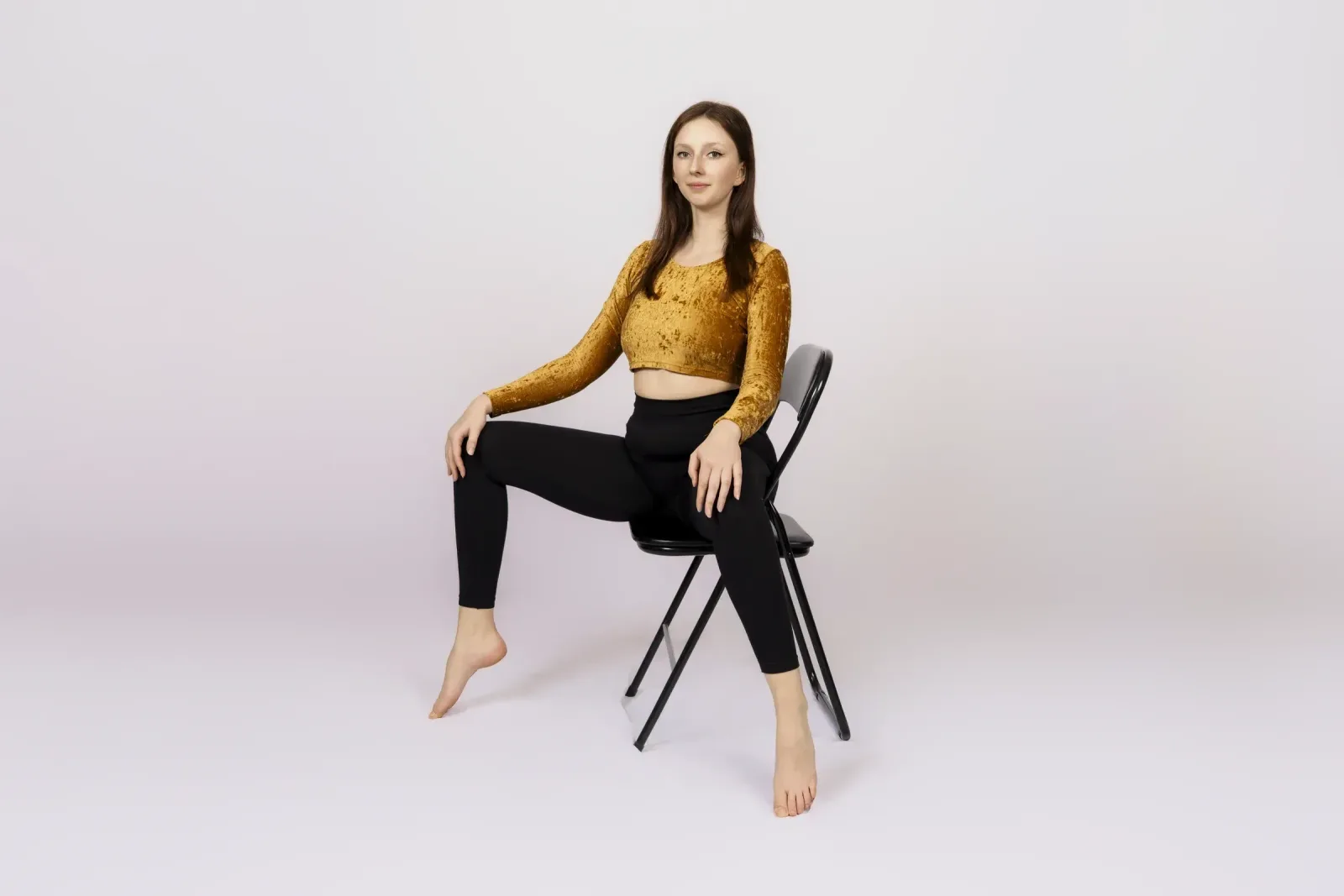 Chairdance – lektorka sedí na židli a dívá se do kamery ve studiu Prostě se hýbej, Opava.