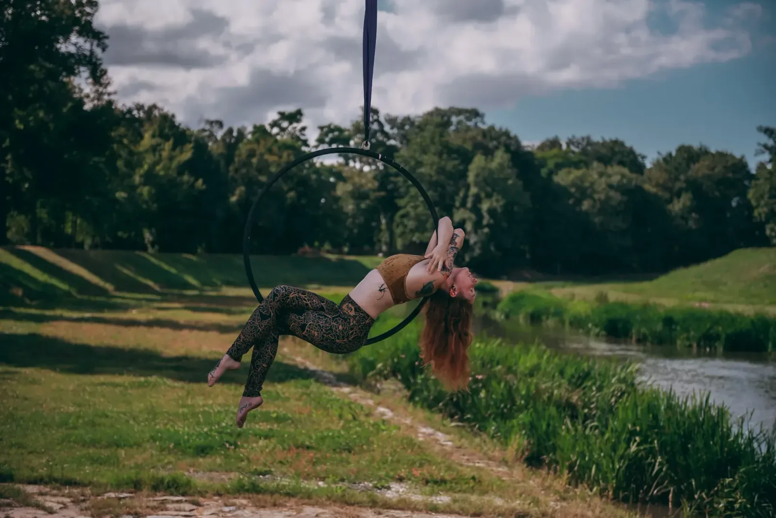 Aerial hoop – lektorka předvádí elegantní prvek s prohnutými zády a splývajícími vlasy ve studiu Prostě se hýbej, Opava.