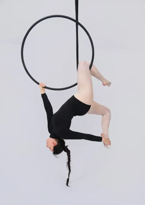 Aerial hoop – lektorka visí hlavou dolů v kruhu a prohýbá záda ve studiu Prostě se hýbej, Opava.