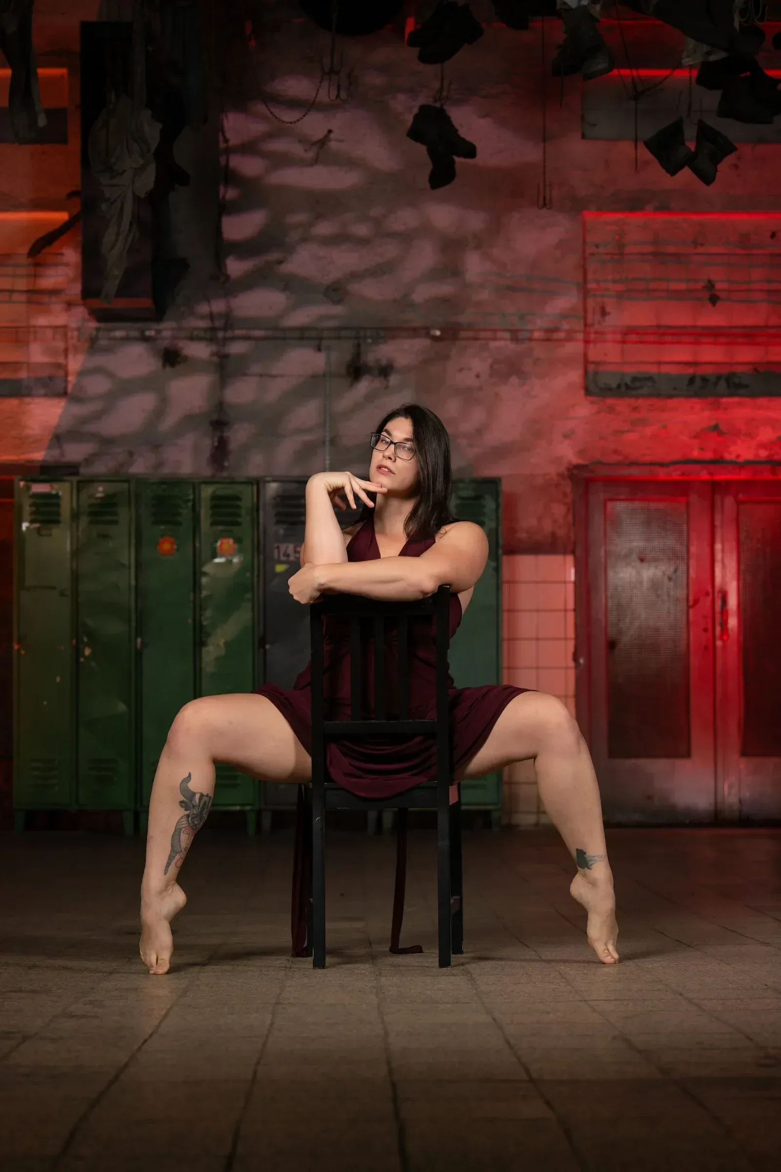 Chairdance – lektorka sedí na židli v širokém rozkroku na špičkách ve studiu Prostě se hýbej, Opava.